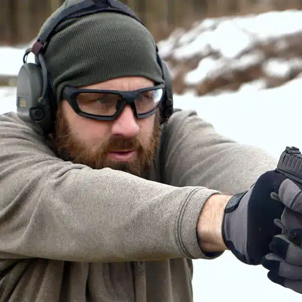 Paul Carlson shooting a pistol on a snowy range
